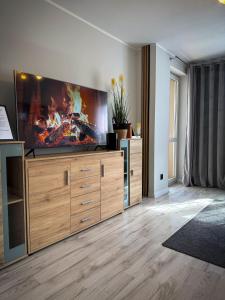 a living room with a large flat screen tv at Apartament Lake Piastowska in Ostróda