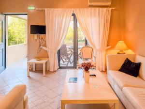 a living room with a couch and a table at Seliandros Aura Villa in Dhiminión