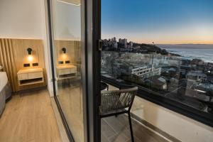 a room with a view of the city from a window at Arka Hotel in Viña del Mar