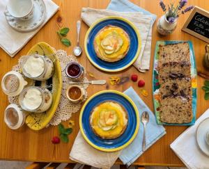 a wooden table with two plates of food on it at B&B Zia Bianca in Vietri sul Mare +22 photos