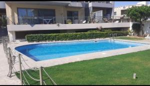 a swimming pool in front of a building at Seaside suite in Crete in Kokkini Khanion