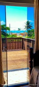 a room with a view of the beach through a sliding glass door at Sobrado Itapoá in Itapoa