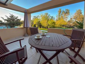 a wooden table and chairs on a balcony at Seliandros Aura Villa in Dhiminión