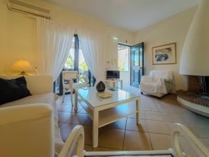 a living room with a couch and a table at Seliandros Aura Villa in Dhiminión +65 photos