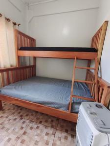 two bunk beds in a room with a printer at Sobrado Itapoá in Itapoa