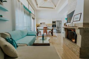 a living room with a couch and a fireplace at Seaside suite in Crete in Kokkini Khanion