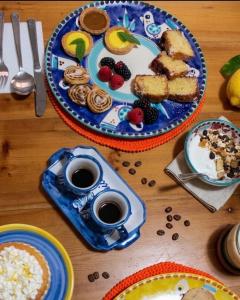a table with plates of food and cups of coffee at B&B Zia Bianca in Vietri sul Mare