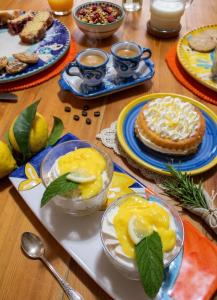 a table topped with plates of food and desserts at B&B Zia Bianca in Vietri sul Mare