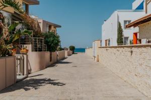 a street with buildings and the ocean in the background at Seaside suite in Crete in Kokkini Khanion