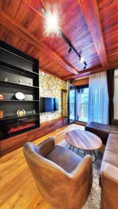 a living room with a couch and a table at Royal Gardens Centar apartmani in Zlatibor