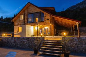 a house with stairs leading up to it at night at Olive Panorama Villa in Dobra Voda