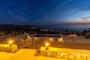 a view of a patio with two lights and tables at Olive Panorama Villa in Dobra Voda