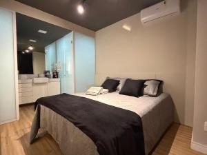 a bedroom with a large bed in a room at Studio aconchegante in Belo Horizonte +18 photos