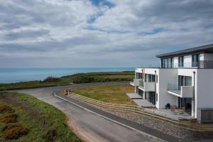 a house on the side of a road at Luxury Sea View Apartments in Bude with Garden, Sleep 6 in Bude +49 photos