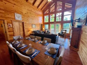 a dining room with a table and chairs in a cabin at Just Right- RRG -Relaxing - Secluded in Slade