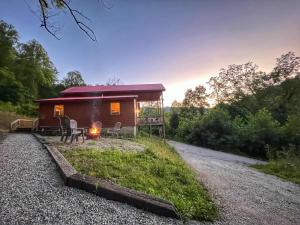 a small cabin with a fire in front of it at Just Right- RRG -Relaxing - Secluded in Slade