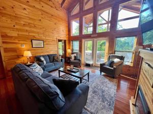 a living room with couches and chairs in a cabin at Just Right- RRG -Relaxing - Secluded in Slade
