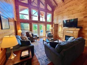 a living room with couches and a television in a cabin at Just Right- RRG -Relaxing - Secluded in Slade +35 photos