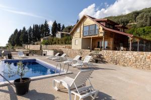 a house with a swimming pool next to a house at Olive Panorama Villa in Dobra Voda
