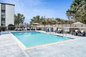 a swimming pool with lounge chairs at Hampton Inn Auburn in Auburn