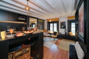 a kitchen with a counter and a living room at Le Boudoir in Lyon