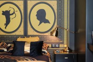 a bedroom with three pictures of a woman on the wall at Le Boudoir in Lyon