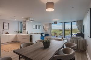 a kitchen and living room with a table and chairs at Luxury Sea View Apartments in Bude with Garden, Sleep 6 in Bude