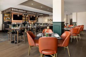 a restaurant with tables and chairs and a bar at Doubletree By Hilton Concord Downtown in Concord
