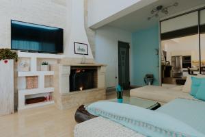 a living room with a couch and a fireplace at Seaside suite in Crete in Kokkini Khanion