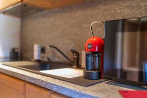 a red appliance sitting on top of a kitchen counter at Chalet Adda - Appartamento mansarda con garage privato in Bormio