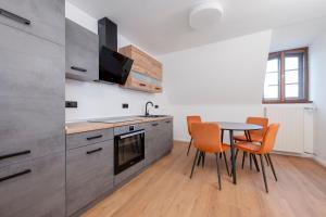 a kitchen with a table and chairs in a room at Hotel Fontana Selb in Selb +18 photos