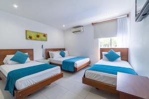 a bedroom with two beds and a window at Casa Serena Hotel Boutique in Melgar +57 photos