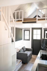 a living room with a couch and a loft bed at Gold Mine Lofts in Idaho City