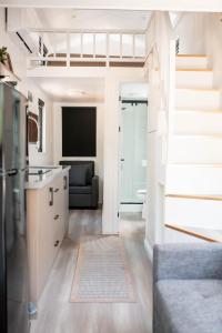 a kitchen and living room with a couch and a television at Gold Mine Lofts in Idaho City +2 photos