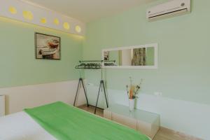 a white room with a bed and a mirror at Seaside suite in Crete in Kokkini Khanion +14 photos