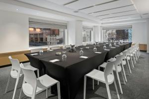 a long conference room with a long table and white chairs at Hotel 55 Chicago Downtown in Chicago