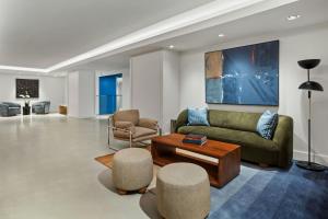 a living room with a couch and a table and chairs at Hotel 55 Chicago Downtown in Chicago