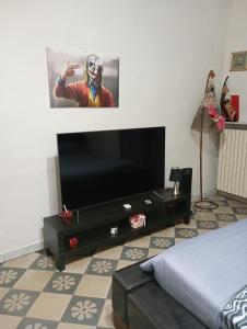 a living room with a flat screen tv and a bed at ARCO in Bisceglie