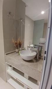 a bathroom with a white sink and a mirror at Centro suite II in Santiago del Estero +28 photos
