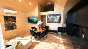 a living room with a table and a couch at Cottage de luxe en bois in Longnes