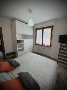 a bedroom with a large bed and a window at Casa Aurea Lake Como Apartment in Esino Lario