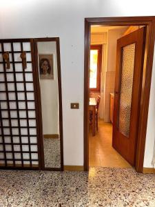 a room with an open door and a room with a door at Casa Aurea Lake Como Apartment in Esino Lario +11 photos