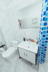a white bathroom with a toilet and a sink at TiLiA Breeze Studio Saturn in Saturn +33 photos
