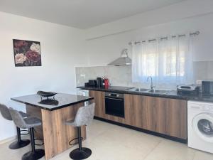 a kitchen with a counter and a sink and a dishwasher at Iliana Apartment in Afantou