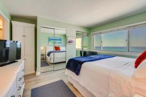 a bedroom with a large bed and a television at ‘Emerald Dreams’ Beach & Lakefront West PCB Condo in Panama City Beach +35 photos