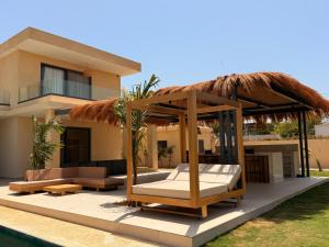 a villa with a bed and a gazebo at Villa Tarrafal in Somone