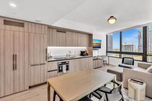 a kitchen and living room with a couch and a table at Beautiful Miami Apt Pool & Beach for 3 Guests in Miami