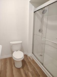 a bathroom with a toilet and a shower at Sunny Ensuite Room with 2 Queen Beds-2A in Halifax