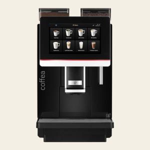 a black and red coffee machine with a cup at Arena Hotel Waldshut in Waldshut-Tiengen