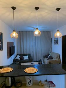 two pizzas on a table in a living room with lights at Praia do Frances-Riviera do Frances casa 37 in Marechal Deodoro